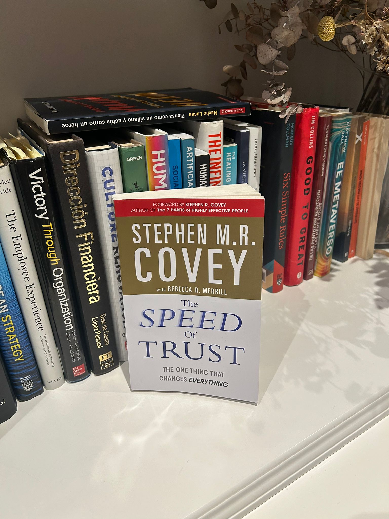 The Speed of Trust by Stephen M. R. Covey standing on a shelf next to other titles
