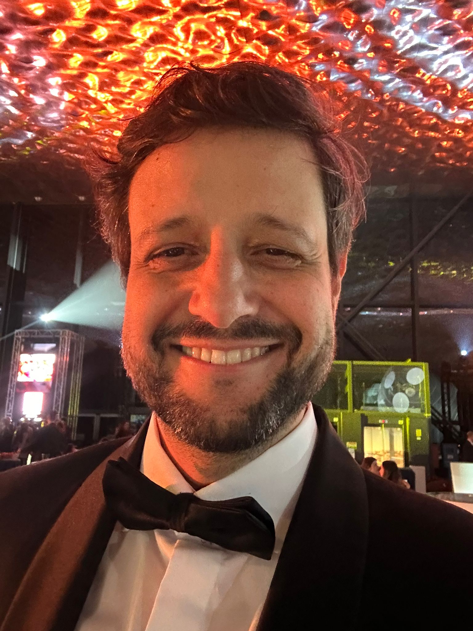 Manu Soriano smiling in a tuxedo and bow tie in December 2025, visibly slimmer