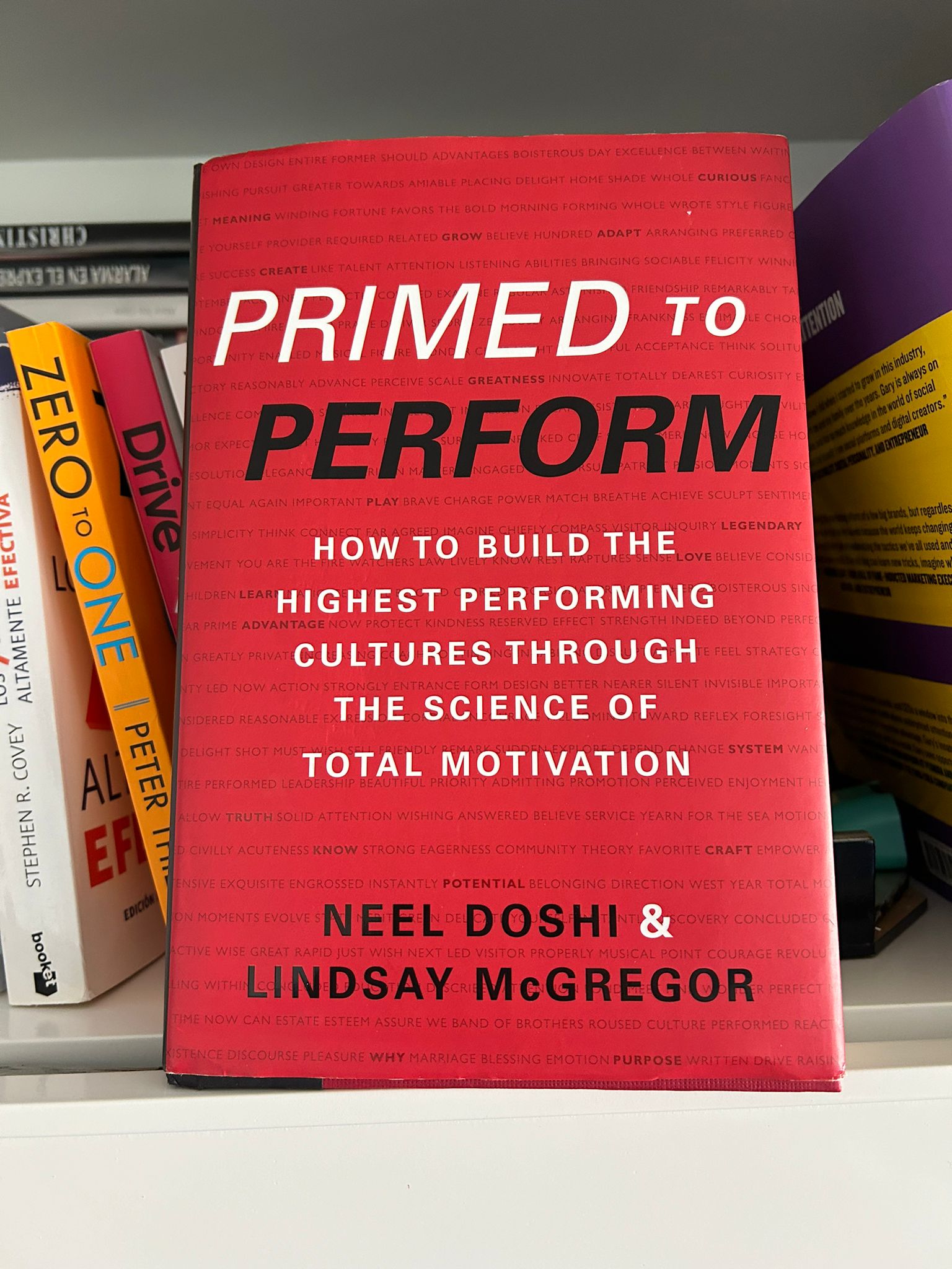 The book Primed to Perform by Neel Doshi and Lindsay McGregor on a shelf