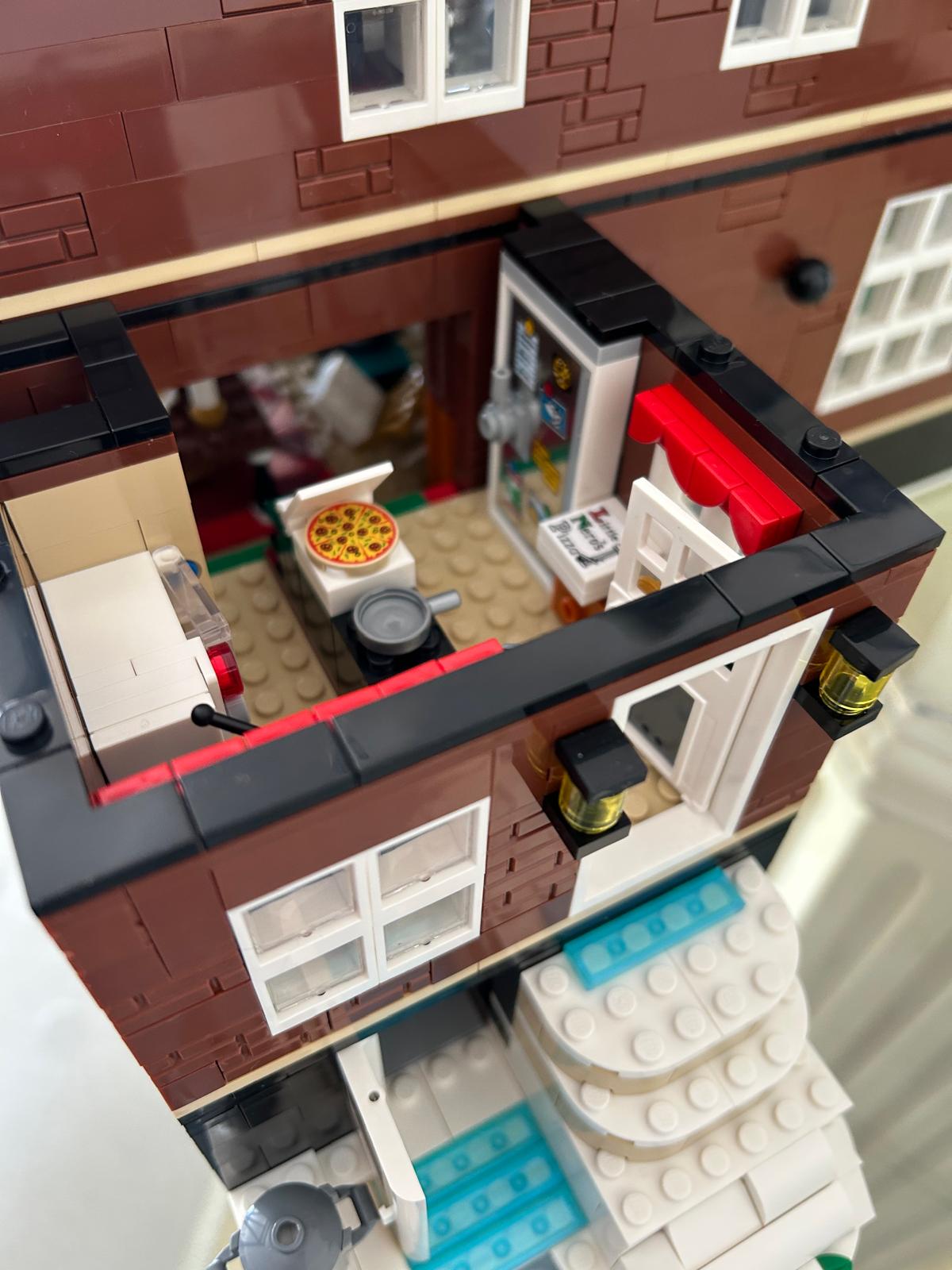 LEGO detail of the Home Alone house kitchen with a pizza and a fridge