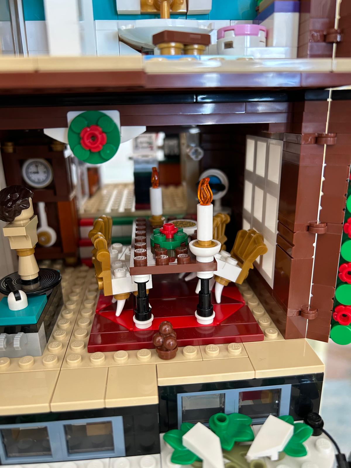 LEGO detail of the Home Alone dining room with a table, chairs and candles