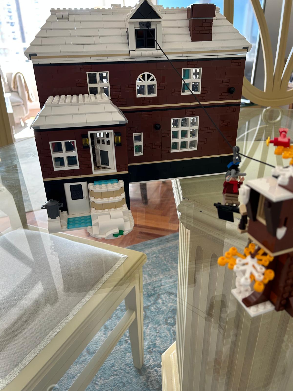 Facade of the LEGO Home Alone house model sitting on a glass table