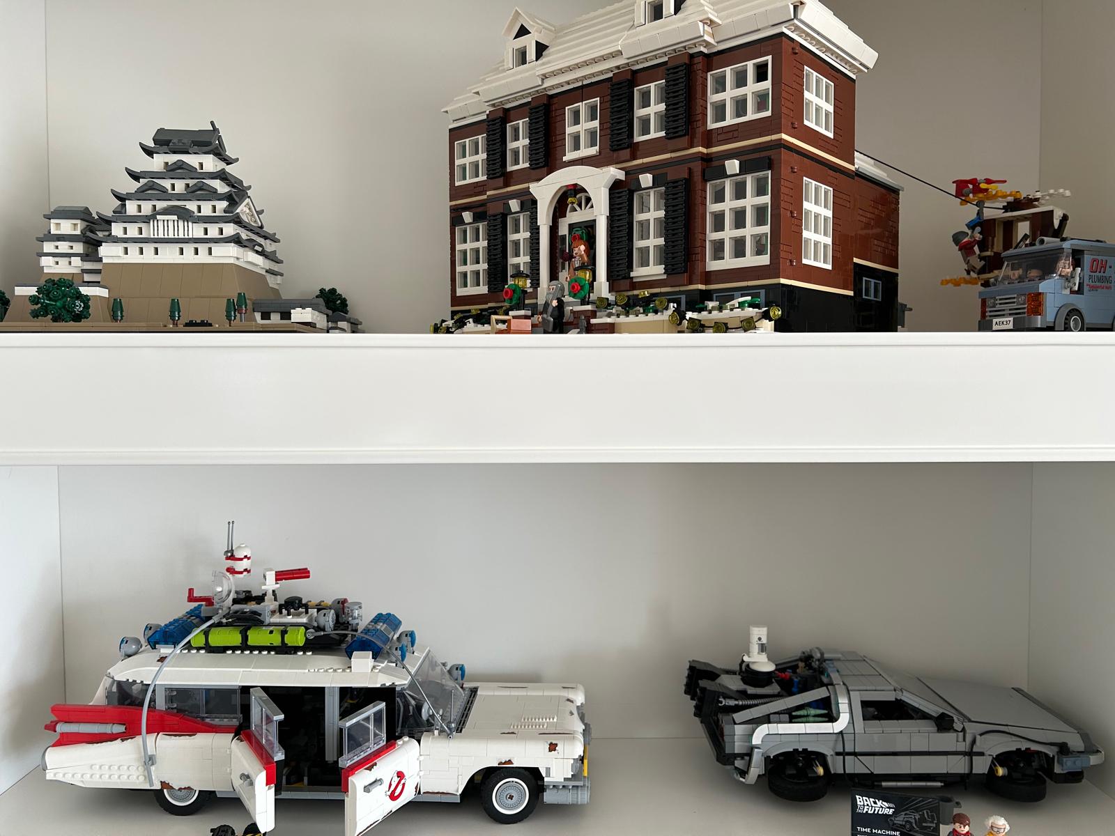 Shelf with LEGO models: the Home Alone house, a Japanese castle, the Ecto-1 and the DeLorean