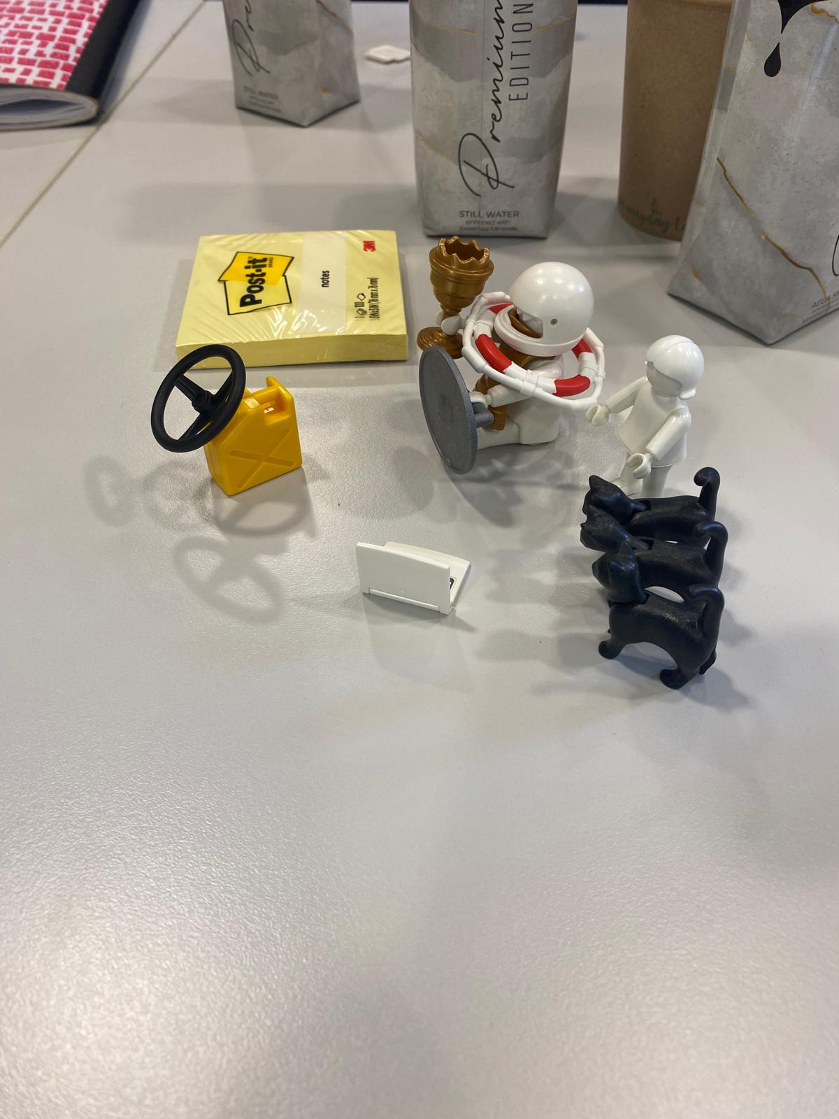 Models built during a LEGO Serious Play session on a table covered with Post-it notes