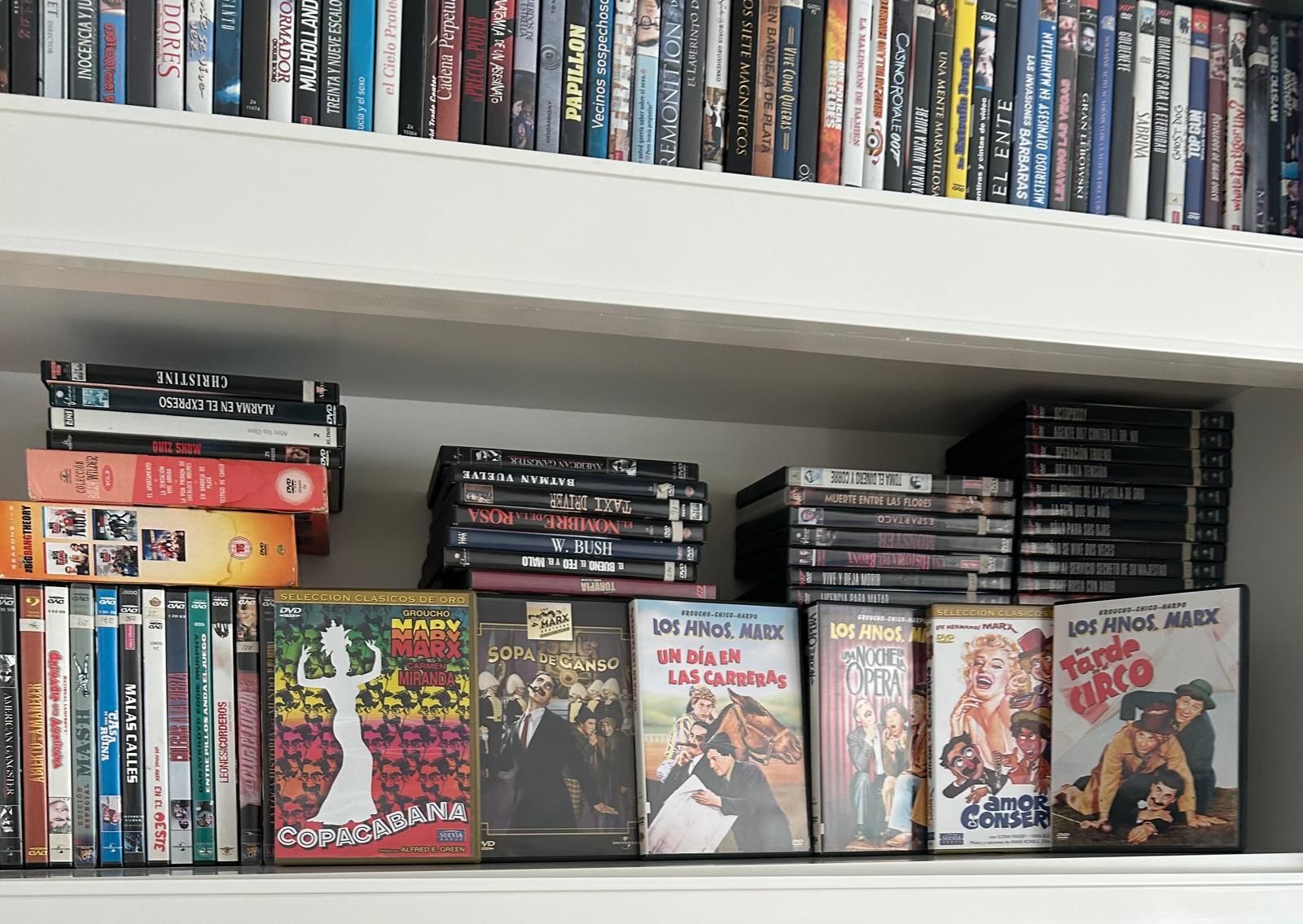 A shelf of Marx Brothers film DVDs like Duck Soup and A Night at the Opera