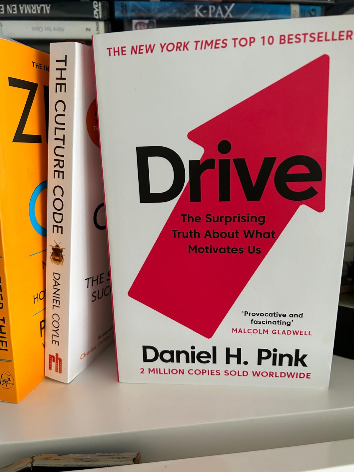 Daniel H. Pink's book Drive on motivation next to The Culture Code on a shelf