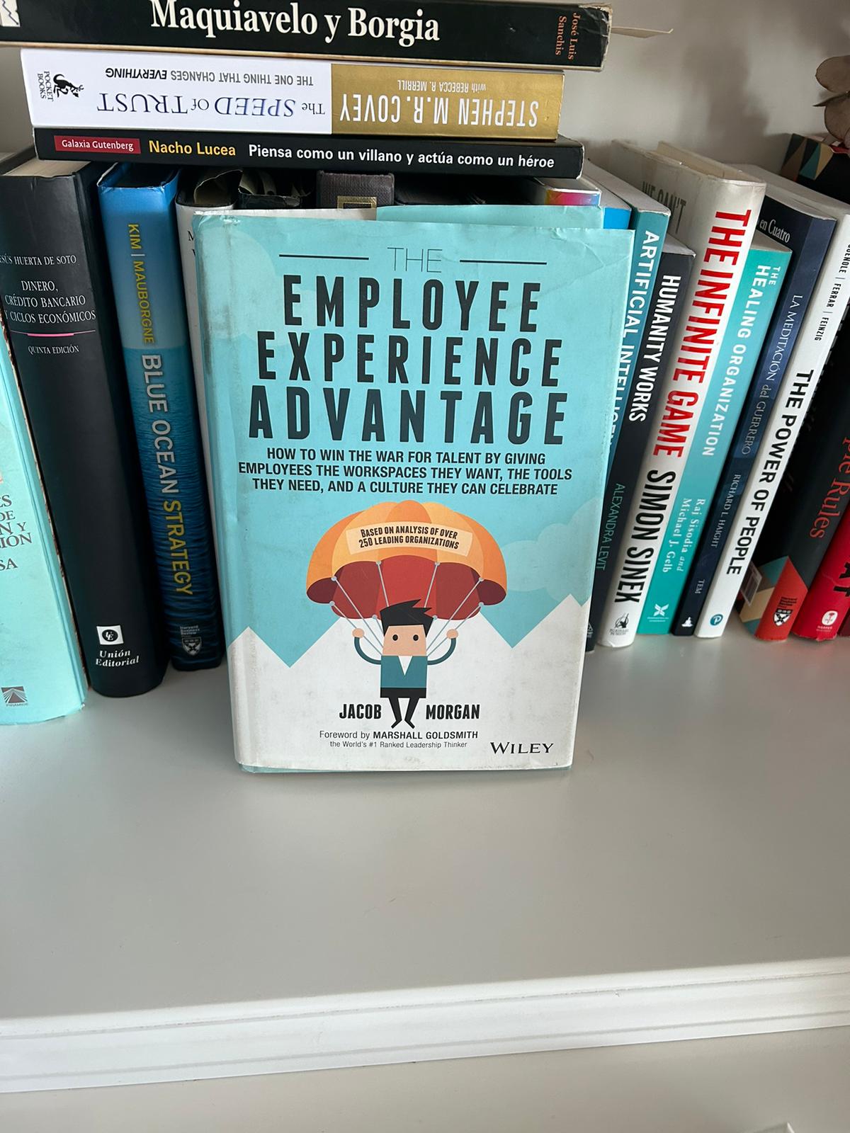 The book The Employee Experience Advantage by Jacob Morgan on a shelf among management classics