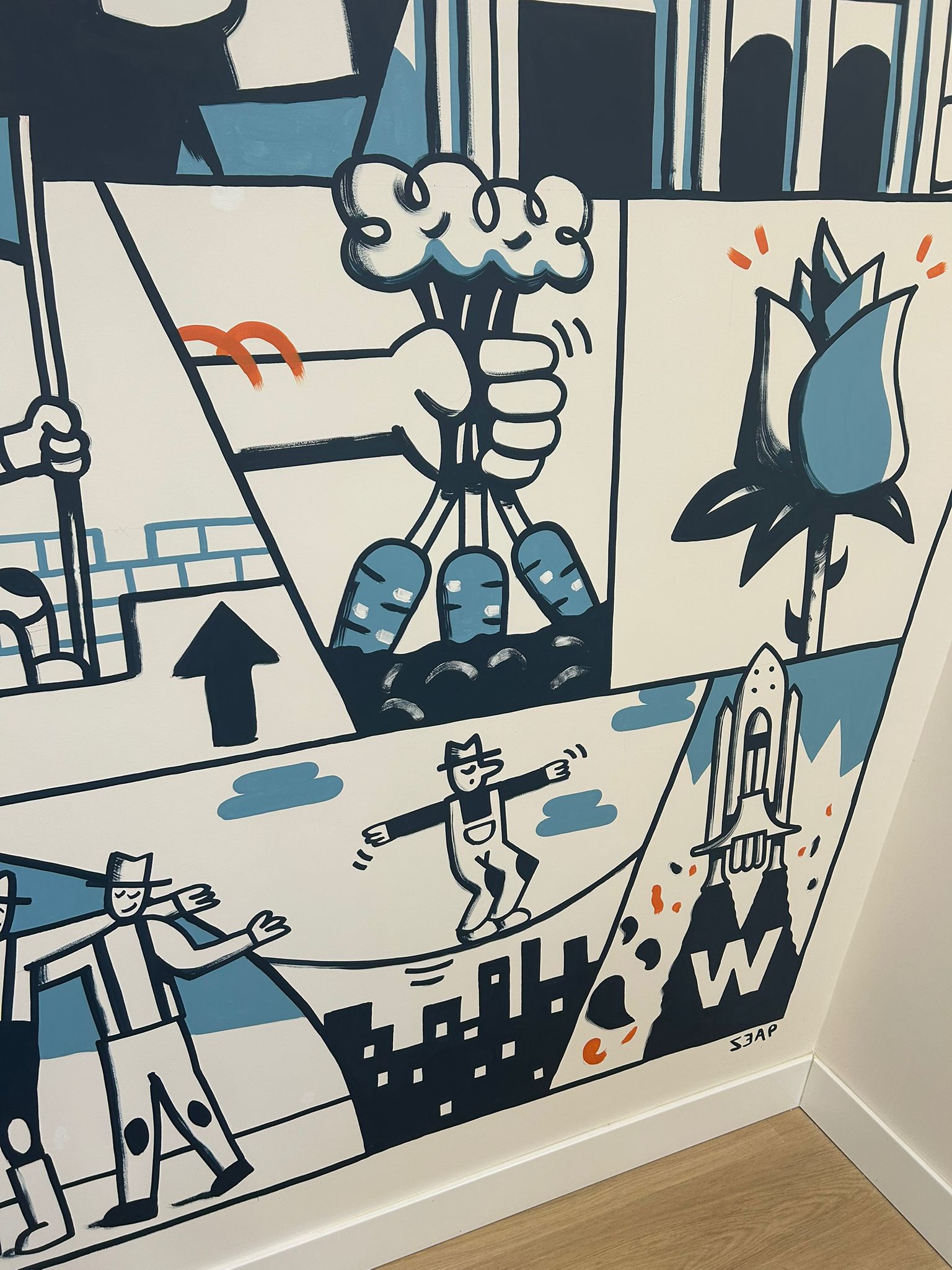 Detail of the mural with a tightrope walker, a symbol of starting from scratch, and a rose